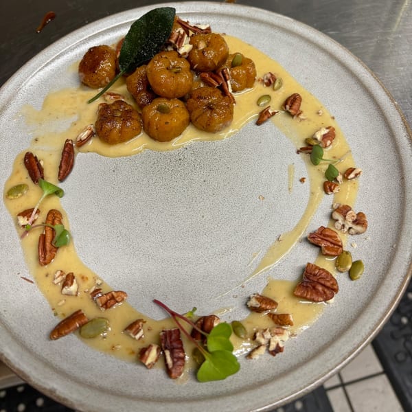 Uncommon Grill's pumpkin gnocchi with sage, pecans, and pumpkin seeds in a creamy sauce.